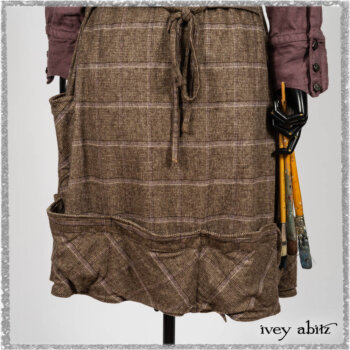 Porte Cochere Frock in Earthen and Plum Stretch Plaid; Fairholme Shirt in Plum Tree Washed Linen; Blanchefleur Sash in Ethereal Floral Cotton Voile. Ivey Abitz bespoke clothing.
