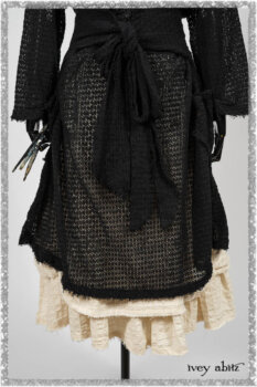 Ardsley Duster Coat in Beacon Black Lace Netted Knit; Ardsleydale Frock in Ethereal Cream Embroidered Crushed Plaid; Clotaire Sash in Ethereal Cream and Black Fleur Stretch Cotton. Ivey Abitz bespoke clothing.