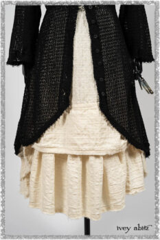 Ardsley Duster Coat in Beacon Black Lace Netted Knit; Ardsleydale Frock in Ethereal Cream Embroidered Crushed Plaid; Clotaire Sash in Ethereal Cream and Black Fleur Stretch Cotton. Ivey Abitz bespoke clothing.