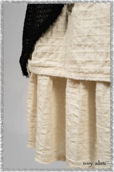 Ardsley Duster Coat in Beacon Black Lace Netted Knit; Ardsleydale Frock in Ethereal Cream Embroidered Crushed Plaid; Clotaire Sash in Ethereal Cream and Black Fleur Stretch Cotton. Ivey Abitz bespoke clothing.