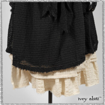 Ardsley Duster Coat in Beacon Black Lace Netted Knit; Clotaire Sash in Ethereal Cream and Black Fleur Stretch Cotton; Ardsley Frock in Beacon Black Hemstitch Stripe Gauze; Ardsleydale Frock in Ethereal Cream Embroidered Crushed Plaid. Ivey Abitz bespoke clothing.