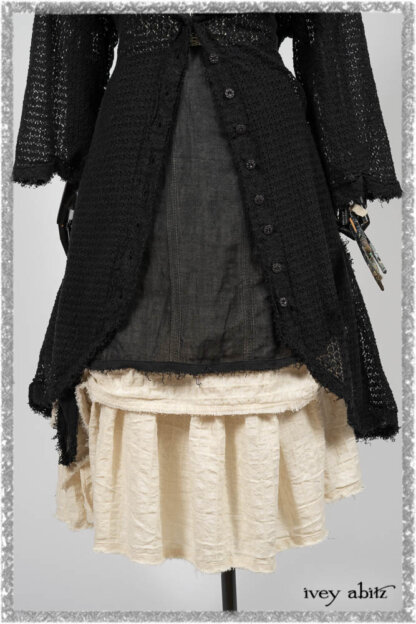 Ardsley Duster Coat in Beacon Black Lace Netted Knit; Clotaire Sash in Ethereal Cream and Black Fleur Stretch Cotton; Ardsley Frock in Beacon Black Hemstitch Stripe Gauze; Ardsleydale Frock in Ethereal Cream Embroidered Crushed Plaid. Ivey Abitz bespoke clothing.