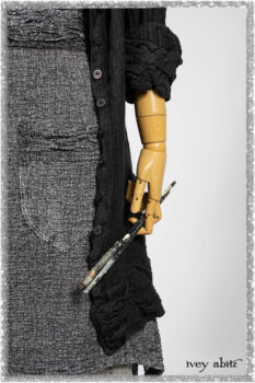 Mewland Jacket in Black Washed Crinkled Linen; Clotaire Sash in Ethereal Cream and Black Fleur Stretch Cotton; Bramley Overlay in Black White Painted Puckery Weave; Mewland Trousers in Beacon Blcak Embroidered Plaid on Petite Stripe. Ivey Abitz bespoke clothing.