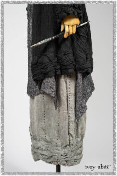 Mewland Jacket in Black Washed Crinkled Linen; Clotaire Sash in Ethereal Cream and Black Fleur Stretch Cotton; Bramley Overlay in Black White Painted Puckery Weave; Mewland Trousers in Beacon Blcak Embroidered Plaid on Petite Stripe. Ivey Abitz bespoke clothing.