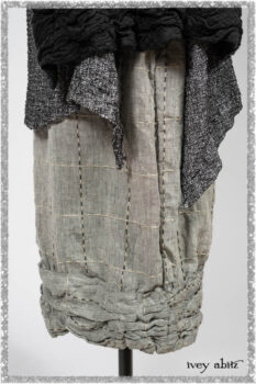 Mewland Jacket in Black Washed Crinkled Linen; Clotaire Sash in Ethereal Cream and Black Fleur Stretch Cotton; Bramley Overlay in Black White Painted Puckery Weave; Mewland Trousers in Beacon Blcak Embroidered Plaid on Petite Stripe. Ivey Abitz bespoke clothing.