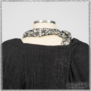 Mewland Jacket in Black Washed Crinkled Linen; Clotaire Sash in Ethereal Cream and Black Fleur Stretch Cotton; Bramley Overlay in Black White Painted Puckery Weave; Mewland Trousers in Beacon Blcak Embroidered Plaid on Petite Stripe. Ivey Abitz bespoke clothing.