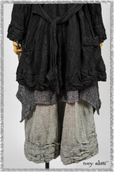 Mewland Jacket in Black Washed Crinkled Linen; Clotaire Sash in Ethereal Cream and Black Fleur Stretch Cotton; Bramley Overlay in Black White Painted Puckery Weave; Mewland Trousers in Beacon Blcak Embroidered Plaid on Petite Stripe. Ivey Abitz bespoke clothing.