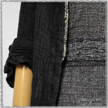 Mewland Jacket in Black Washed Crinkled Linen; Clotaire Sash in Ethereal Cream and Black Fleur Stretch Cotton; Bramley Overlay in Black White Painted Puckery Weave; Mewland Trousers in Beacon Blcak Embroidered Plaid on Petite Stripe. Ivey Abitz bespoke clothing.