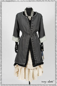 Trelawny Duster Coat in Estuary and Black Houndstooth on Pinstripe; Trelawny Vest in Beacon Black Hemstitch Stripe Gauze; Clotaire Sash in Ethereal Cream and Black Fleur Stretch Cotton; Ardsleydale Frock in Ethereal Cream Embroidered Crushed Plaid. Ivey Abitz bespoke clothing.