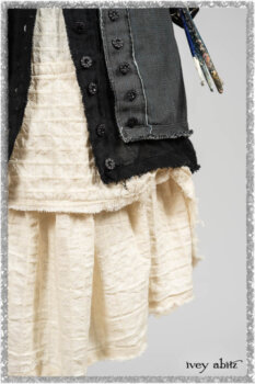 Trelawny Duster Coat in Estuary and Black Houndstooth on Pinstripe; Trelawny Vest in Beacon Black Hemstitch Stripe Gauze; Clotaire Sash in Ethereal Cream and Black Fleur Stretch Cotton; Ardsleydale Frock in Ethereal Cream Embroidered Crushed Plaid. Ivey Abitz bespoke clothing.