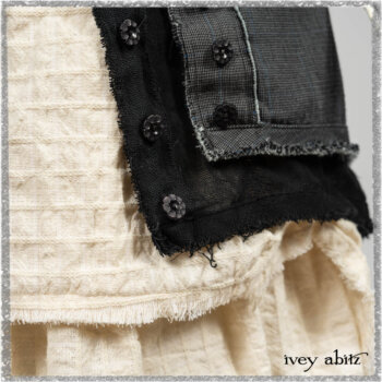 Trelawny Duster Coat in Estuary and Black Houndstooth on Pinstripe; Trelawny Vest in Beacon Black Hemstitch Stripe Gauze; Clotaire Sash in Ethereal Cream and Black Fleur Stretch Cotton; Ardsleydale Frock in Ethereal Cream Embroidered Crushed Plaid. Ivey Abitz bespoke clothing.