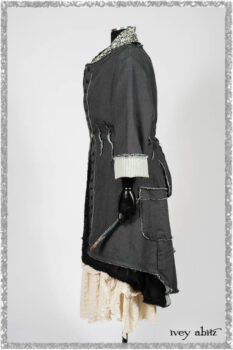 Trelawny Duster Coat in Estuary and Black Houndstooth on Pinstripe; Trelawny Vest in Beacon Black Hemstitch Stripe Gauze; Clotaire Sash in Ethereal Cream and Black Fleur Stretch Cotton; Ardsleydale Frock in Ethereal Cream Embroidered Crushed Plaid. Ivey Abitz bespoke clothing.