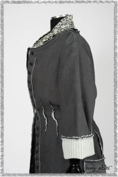 Trelawny Duster Coat in Estuary and Black Houndstooth on Pinstripe; Trelawny Vest in Beacon Black Hemstitch Stripe Gauze; Clotaire Sash in Ethereal Cream and Black Fleur Stretch Cotton; Ardsleydale Frock in Ethereal Cream Embroidered Crushed Plaid. Ivey Abitz bespoke clothing.