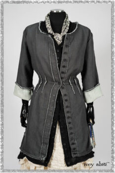 Trelawny Duster Coat in Estuary and Black Houndstooth on Pinstripe; Trelawny Vest in Beacon Black Hemstitch Stripe Gauze; Clotaire Sash in Ethereal Cream and Black Fleur Stretch Cotton; Ardsleydale Frock in Ethereal Cream Embroidered Crushed Plaid. Ivey Abitz bespoke clothing.