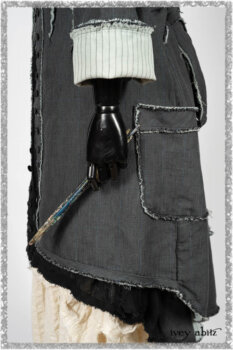 Trelawny Duster Coat in Estuary and Black Houndstooth on Pinstripe; Trelawny Vest in Beacon Black Hemstitch Stripe Gauze; Clotaire Sash in Ethereal Cream and Black Fleur Stretch Cotton; Ardsleydale Frock in Ethereal Cream Embroidered Crushed Plaid. Ivey Abitz bespoke clothing.