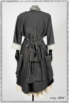 Trelawny Duster Coat in Estuary and Black Houndstooth on Pinstripe; Trelawny Vest in Beacon Black Hemstitch Stripe Gauze; Clotaire Sash in Ethereal Cream and Black Fleur Stretch Cotton; Ardsleydale Frock in Ethereal Cream Embroidered Crushed Plaid. Ivey Abitz bespoke clothing.