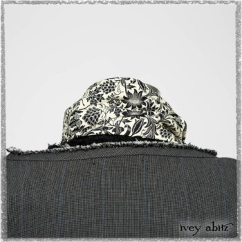 Trelawny Duster Coat in Estuary and Black Houndstooth on Pinstripe; Trelawny Vest in Beacon Black Hemstitch Stripe Gauze; Clotaire Sash in Ethereal Cream and Black Fleur Stretch Cotton; Ardsleydale Frock in Ethereal Cream Embroidered Crushed Plaid. Ivey Abitz bespoke clothing.