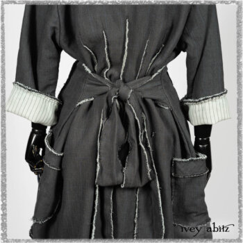 Trelawny Duster Coat in Estuary and Black Houndstooth on Pinstripe; Trelawny Vest in Beacon Black Hemstitch Stripe Gauze; Clotaire Sash in Ethereal Cream and Black Fleur Stretch Cotton; Ardsleydale Frock in Ethereal Cream Embroidered Crushed Plaid. Ivey Abitz bespoke clothing.