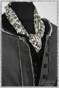 Trelawny Duster Coat in Estuary and Black Houndstooth on Pinstripe; Trelawny Vest in Beacon Black Hemstitch Stripe Gauze; Clotaire Sash in Ethereal Cream and Black Fleur Stretch Cotton; Ardsleydale Frock in Ethereal Cream Embroidered Crushed Plaid. Ivey Abitz bespoke clothing.