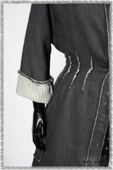 Trelawny Duster Coat in Estuary and Black Houndstooth on Pinstripe; Trelawny Vest in Beacon Black Hemstitch Stripe Gauze; Clotaire Sash in Ethereal Cream and Black Fleur Stretch Cotton; Ardsleydale Frock in Ethereal Cream Embroidered Crushed Plaid. Ivey Abitz bespoke clothing.
