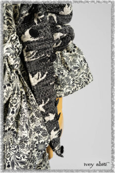 Elliot Jacket in Beacon Black Flora and Fauna Knit; Tollie Dress in Estuary Cream and Black Fleur Stretch Cotton; Clotaire Sash in Ethereal Cream and Black Fleur Stretch Cotton; Mewland Skirt in Black Washed Crinkled Linen. Ivey Abitz bespoke clothing.