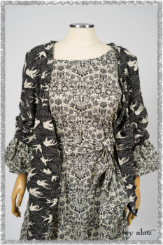 Elliot Jacket in Beacon Black Flora and Fauna Knit; Tollie Dress in Estuary Cream and Black Fleur Stretch Cotton; Clotaire Sash in Ethereal Cream and Black Fleur Stretch Cotton; Mewland Skirt in Black Washed Crinkled Linen. Ivey Abitz bespoke clothing.