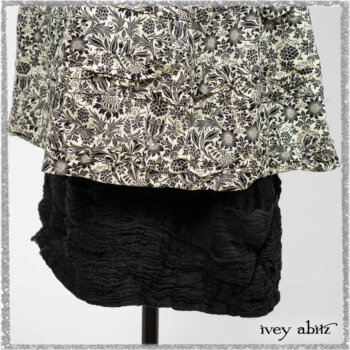 Elliot Jacket in Beacon Black Flora and Fauna Knit; Tollie Dress in Estuary Cream and Black Fleur Stretch Cotton; Clotaire Sash in Ethereal Cream and Black Fleur Stretch Cotton; Mewland Skirt in Black Washed Crinkled Linen. Ivey Abitz bespoke clothing.