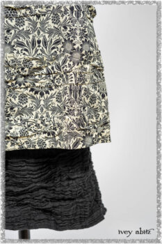 Elliot Jacket in Beacon Black Flora and Fauna Knit; Tollie Dress in Estuary Cream and Black Fleur Stretch Cotton; Clotaire Sash in Ethereal Cream and Black Fleur Stretch Cotton; Mewland Skirt in Black Washed Crinkled Linen. Ivey Abitz bespoke clothing.