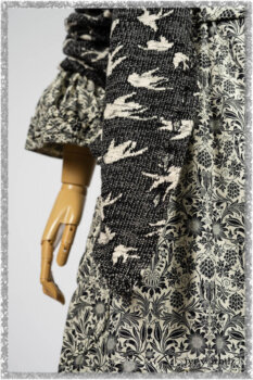 Elliot Jacket in Beacon Black Flora and Fauna Knit; Tollie Dress in Estuary Cream and Black Fleur Stretch Cotton; Clotaire Sash in Ethereal Cream and Black Fleur Stretch Cotton; Mewland Skirt in Black Washed Crinkled Linen. Ivey Abitz bespoke clothing.