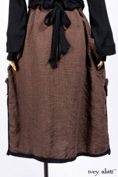 Hudson Jacket in Signature Black Ribbed Knit; Roebling Frock in Brownstone Washed Linen; Lydia Neck Wrap and Lydia Arm Wraps in Signature Black Washed Knit; Cilla Slip Frock in Signature Black Ribbed Knit.