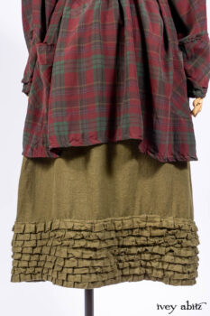 Pierrepont Shirt in Brooklyn Washed Plaid Silk; Limited Edition Clotaire Sash in Central Park Plaid Silk; Cape Frock in Central Park Washed Linen; Cilla Slip Frock in Signature Black Ribbed Knit.