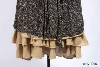 Baudelaire Duster Coat in Mansard Roof and Sandstone Washed Crepe; Delphine Dress in Mansard Roof and Sandstone Sprig Silk Chiffon; Lydia Neck Wrap and Lydia Arm Sleeves in Signature Black Washed Knit; Everett Frock in Sandstone Washed Weave.