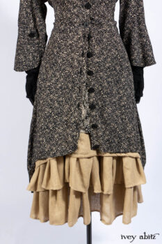Baudelaire Duster Coat in Mansard Roof and Sandstone Washed Crepe; Delphine Dress in Mansard Roof and Sandstone Sprig Silk Chiffon; Lydia Neck Wrap and Lydia Arm Sleeves in Signature Black Washed Knit; Everett Frock in Sandstone Washed Weave.