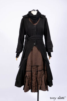 Everett Duster Coat in Mansard Roof Coat Weave; Lydia Neck Wrap and Lydia Arm Wraps in Signature Black Washed Knit; Roebling Frock in Brownstone Washed Linen; Cilla Slip Frock in Signature Black Washed Knit.
