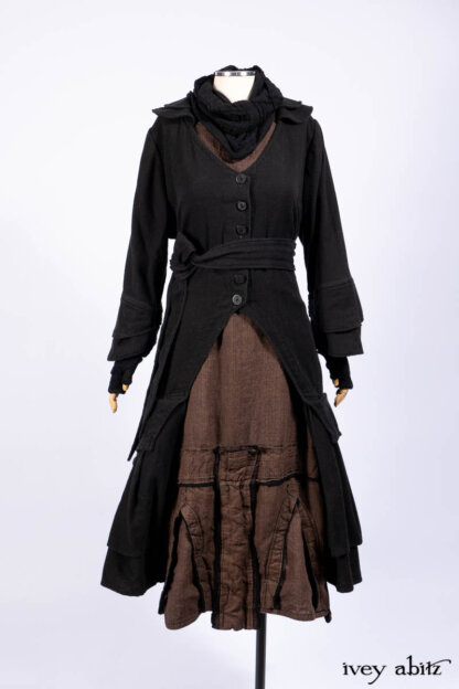 Everett Duster Coat in Mansard Roof Coat Weave; Lydia Neck Wrap and Lydia Gloves in Signature Black Washed Knit; Roebling Frock in Brownstone Washed Linen; Cilla Slip Frock in Signature Black Washed Knit.