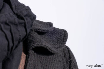 Everett Duster Coat in Mansard Roof Coat Weave; Lydia Neck Wrap and Lydia Arm Wraps in Signature Black Washed Knit; Roebling Frock in Brownstone Washed Linen; Cilla Slip Frock in Signature Black Washed Knit.