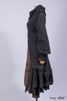 Everett Duster Coat in Mansard Roof Coat Weave; Lydia Neck Wrap and Lydia Arm Wraps in Signature Black Washed Knit; Roebling Frock in Brownstone Washed Linen; Cilla Slip Frock in Signature Black Washed Knit.
