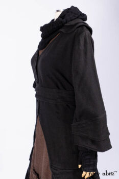 Everett Duster Coat in Mansard Roof Coat Weave; Lydia Neck Wrap and Lydia Arm Wraps in Signature Black Washed Knit; Roebling Frock in Brownstone Washed Linen; Cilla Slip Frock in Signature Black Washed Knit.
