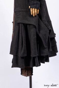 Everett Duster Coat in Mansard Roof Coat Weave; Lydia Neck Wrap and Lydia Arm Wraps in Signature Black Washed Knit; Roebling Frock in Brownstone Washed Linen; Cilla Slip Frock in Signature Black Washed Knit.