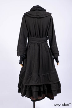 Everett Duster Coat in Mansard Roof Coat Weave; Lydia Neck Wrap and Lydia Arm Wraps in Signature Black Washed Knit; Roebling Frock in Brownstone Washed Linen; Cilla Slip Frock in Signature Black Washed Knit.