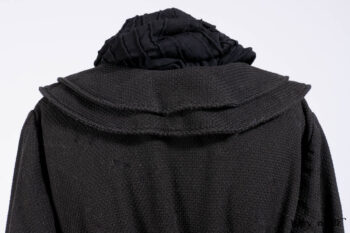 Everett Duster Coat in Mansard Roof Coat Weave; Lydia Neck Wrap and Lydia Arm Wraps in Signature Black Washed Knit; Roebling Frock in Brownstone Washed Linen; Cilla Slip Frock in Signature Black Washed Knit.