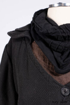 Everett Duster Coat in Mansard Roof Coat Weave; Lydia Neck Wrap and Lydia Arm Wraps in Signature Black Washed Knit; Roebling Frock in Brownstone Washed Linen; Cilla Slip Frock in Signature Black Washed Knit.