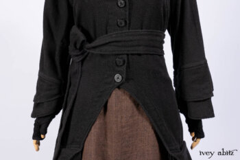Everett Duster Coat in Mansard Roof Coat Weave; Lydia Neck Wrap and Lydia Arm Wraps in Signature Black Washed Knit; Roebling Frock in Brownstone Washed Linen; Cilla Slip Frock in Signature Black Washed Knit.