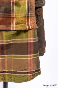 Harrison Duster Coat in Brownstone Crewel Work Weave; Ellis Shirt in Rooftop Sunset Washed Voile; Harrison Frock in Central Park Brownstone Plaid Silk; Cilla Slip Frock in Signature Black Ribbed Knit.