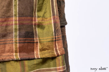 Harrison Duster Coat in Brownstone Crewel Work Weave; Ellis Shirt in Rooftop Sunset Washed Voile; Harrison Frock in Central Park Brownstone Plaid Silk; Cilla Slip Frock in Signature Black Ribbed Knit.