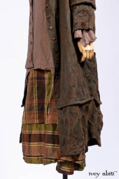 Harrison Duster Coat in Brownstone Crewel Work Weave; Ellis Shirt in Rooftop Sunset Washed Voile; Harrison Frock in Central Park Brownstone Plaid Silk; Cilla Slip Frock in Signature Black Ribbed Knit.
