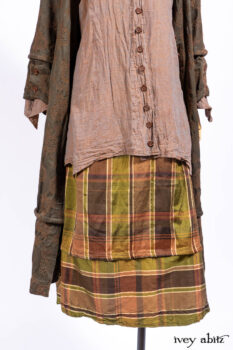 Harrison Duster Coat in Brownstone Crewel Work Weave; Ellis Shirt in Rooftop Sunset Washed Voile; Harrison Frock in Central Park Brownstone Plaid Silk; Cilla Slip Frock in Signature Black Ribbed Knit.