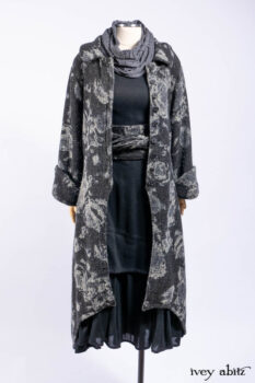 Monceau Duster Coat in Mansard Roof Washed Floral Woolen Weave; Lydia Neck Wrap in Slate Washed Linen; Blanchefleur Dress in Mansard Roof Washed Weave; Cilla Slip Frock in Signature Black Ribbed Knit; Porte Cochere Sash in Mansard Roof Washed Floral Woolen Weave.