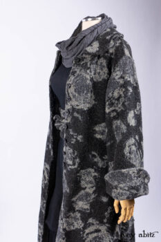 Monceau Duster Coat in Mansard Roof Washed Floral Woolen Weave; Lydia Neck Wrap in Slate Washed Linen; Blanchefleur Dress in Mansard Roof Washed Weave; Cilla Slip Frock in Signature Black Ribbed Knit; Porte Cochere Sash in Mansard Roof Washed Floral Woolen Weave.