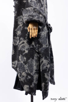 Monceau Duster Coat in Mansard Roof Washed Floral Woolen Weave; Lydia Neck Wrap in Slate Washed Linen; Blanchefleur Dress in Mansard Roof Washed Weave; Cilla Slip Frock in Signature Black Ribbed Knit; Porte Cochere Sash in Mansard Roof Washed Floral Woolen Weave.